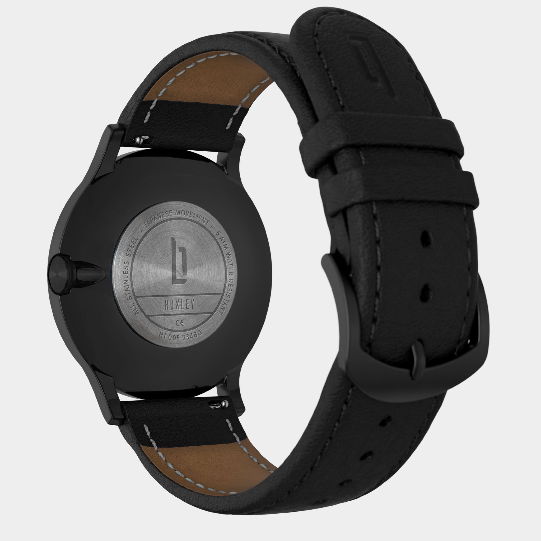 Back view of a black stainless steel watch with Huxley engraving and black leather strap