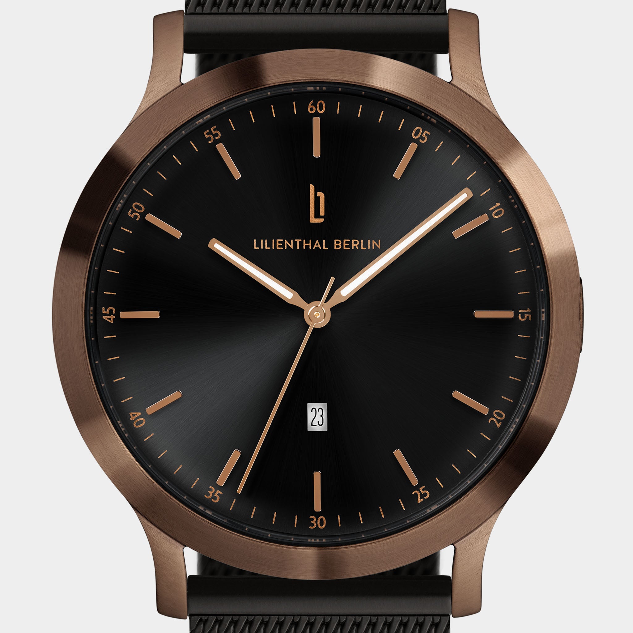 Minimalist black watch face with rose gold case, date window, and mesh strap.