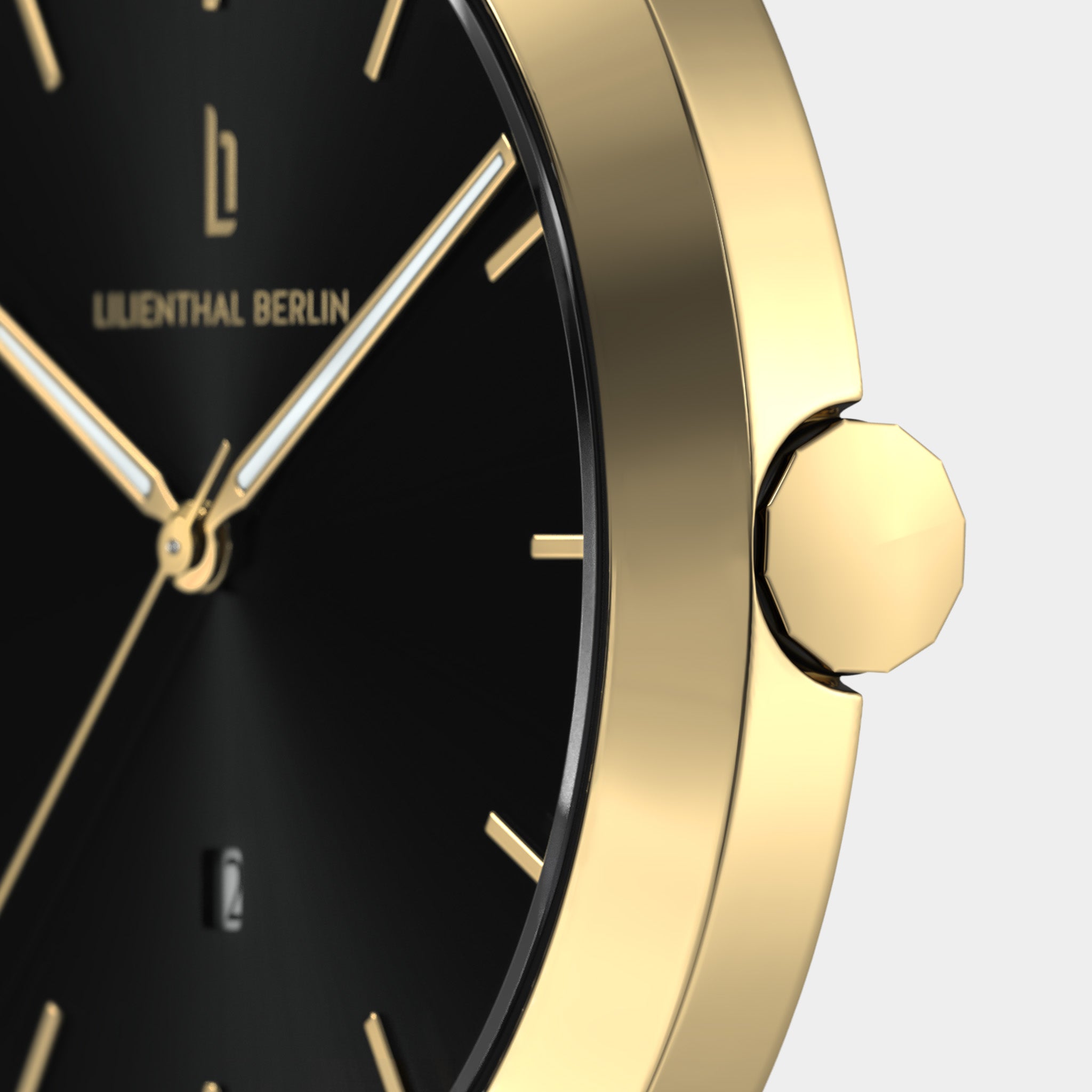 Gold watch with black dial, minimal hour markers, and date window, close-up view