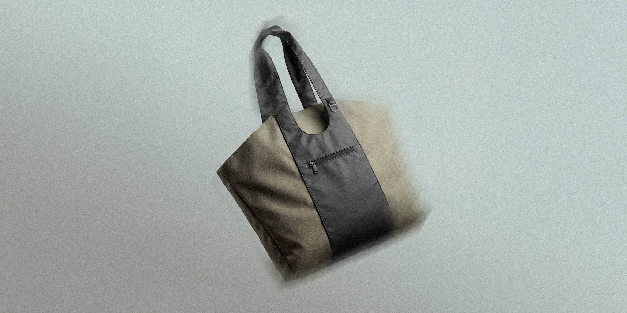 Modern beige and black tote bag with front zipper pocket and double handles