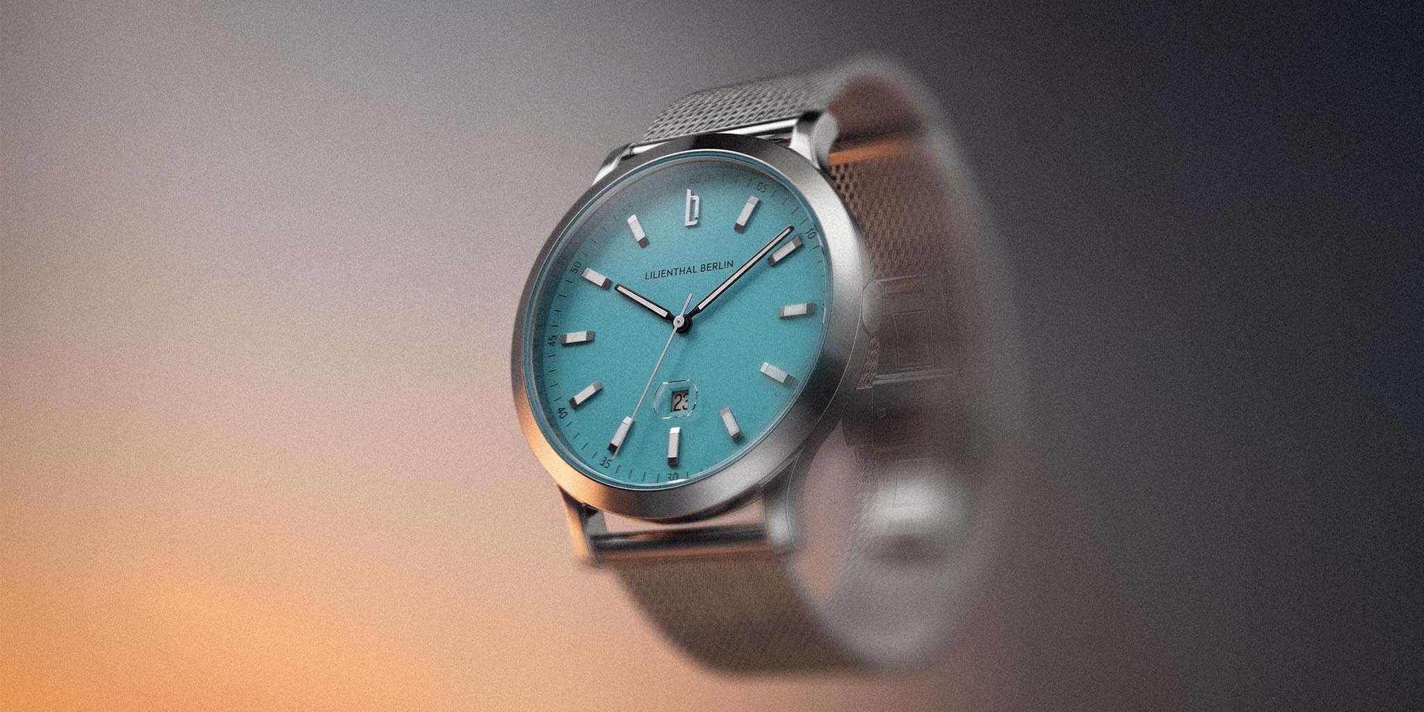 Elegant wristwatch with azure blue dial, date display, and mesh metal strap