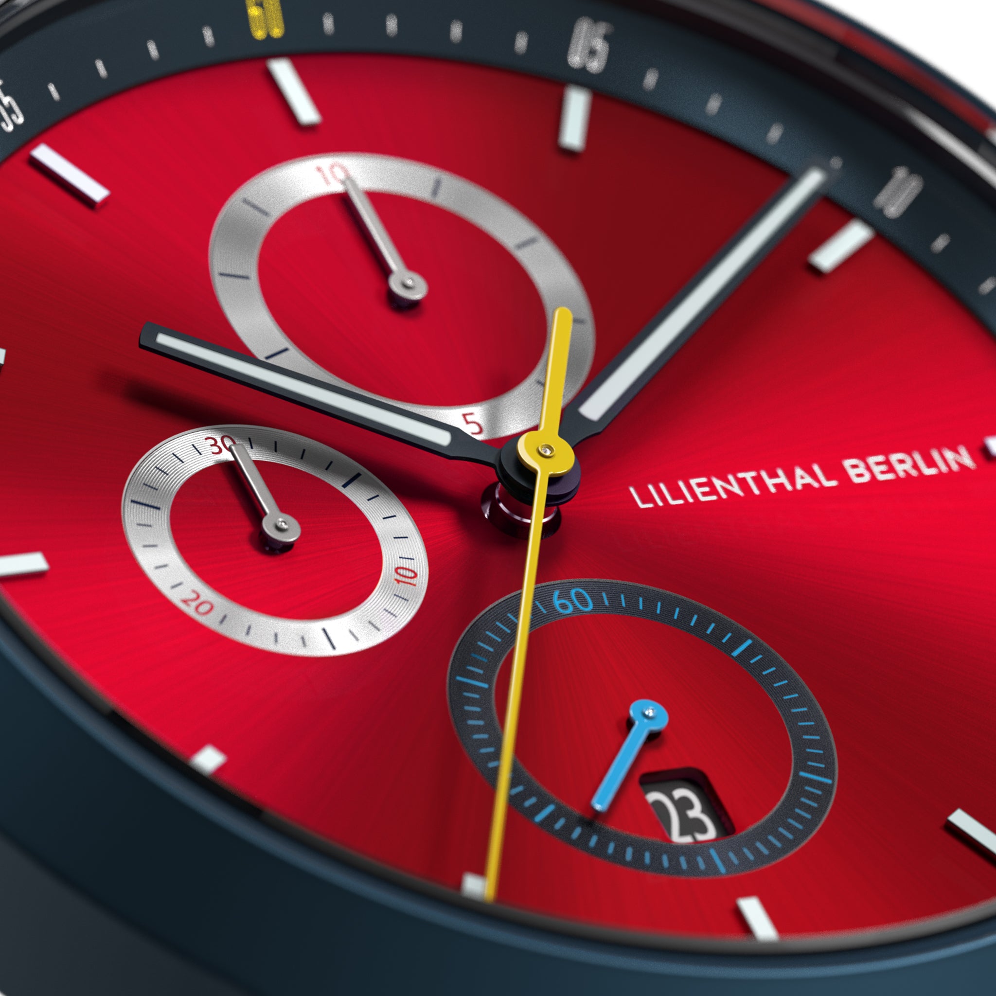 Close-up of red chronograph watch face with subdials, date display, and bold hands