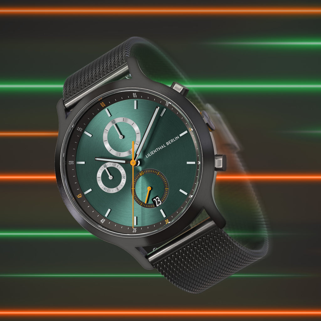 Modern green dial chronograph watch with black mesh strap against neon stripe background
