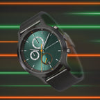 Modern green dial chronograph watch with black mesh strap against neon stripe background