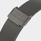 Close-up of a stainless steel mesh watch strap with clasp and engraved branding