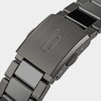 Close-up of brushed metal watch clasp with engraved logo and stainless steel bracelet