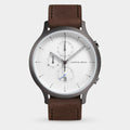 Minimalist men's wristwatch with brown leather strap, white dial, chronograph subdials, and date display