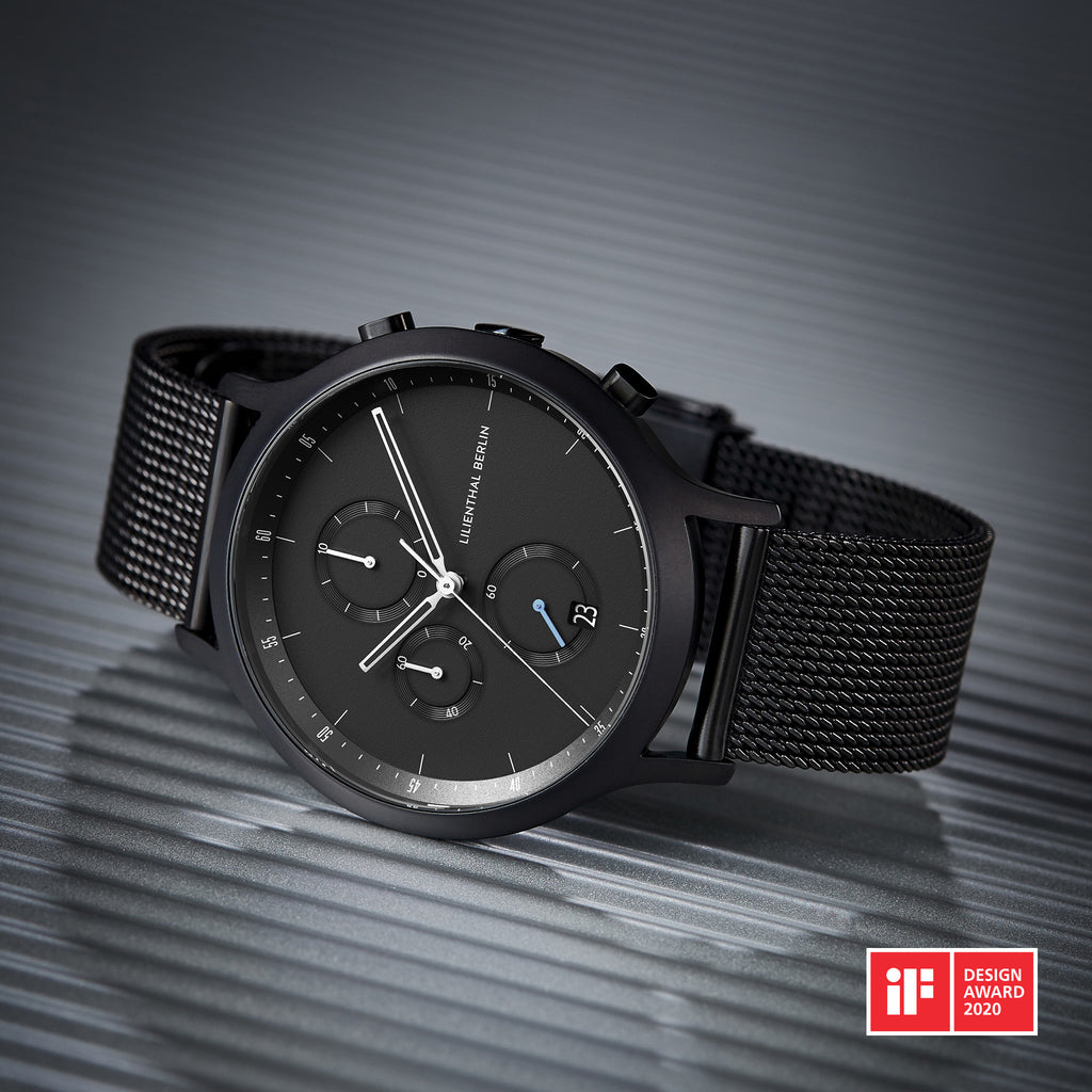 Black mesh strap chronograph watch with date display, minimalist dial, and iF Design Award 2020.