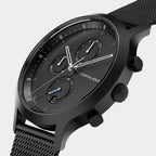 Black chronograph watch with mesh strap, multi-dial face, and minimalist design
