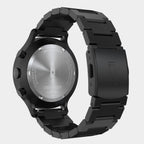 Back view of a black stainless steel chronograph watch with engraved case and metal bracelet