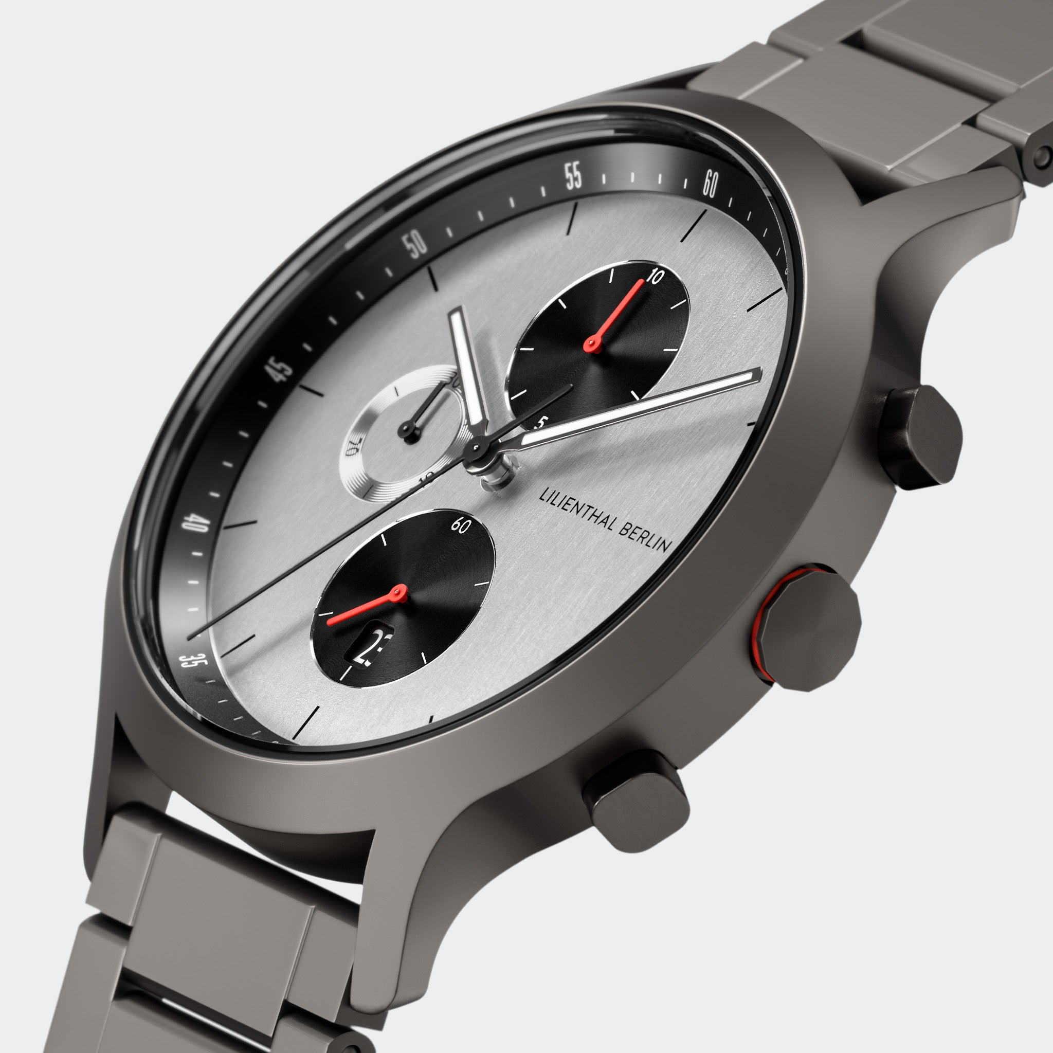 Modern stainless steel chronograph watch with silver dial, black subdials, and red accents.