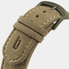 Textured beige suede watch strap with matte metal buckle and visible stitching, close-up.
