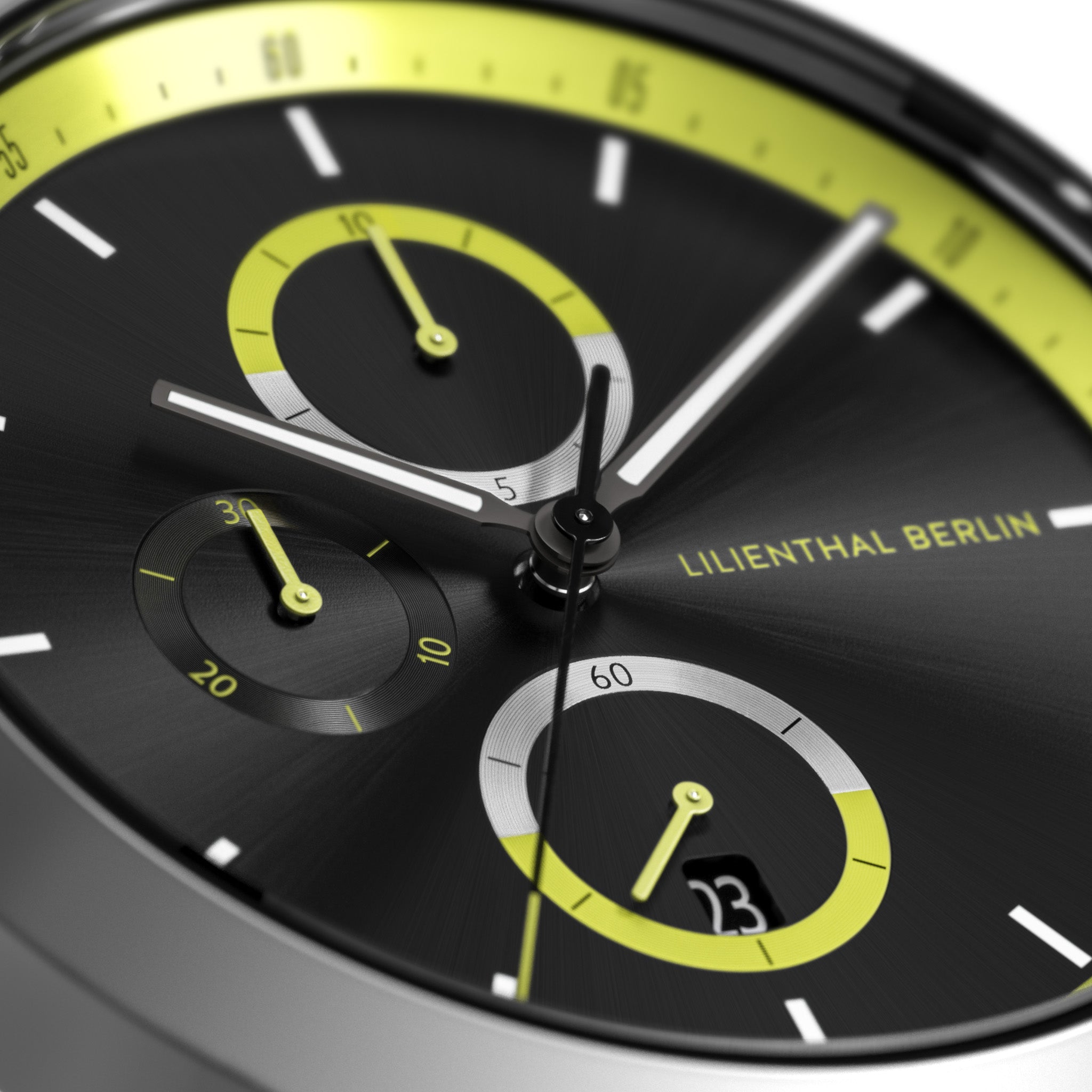 Close-up of modern chronograph watch face with yellow accents, subdials, and date display