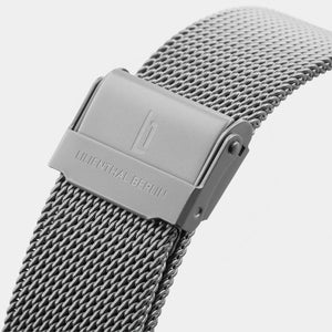 Close-up of mesh stainless steel watch strap with engraved clasp and modern design