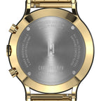 Close-up of gold chronograph watch case back with steel engraving and branded logo
