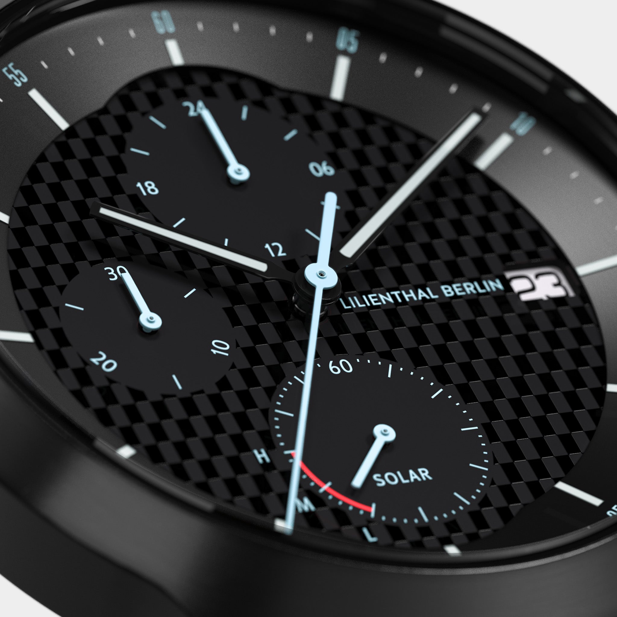 Close-up of black chronograph watch face with carbon fiber texture, subdials, and solar indicator