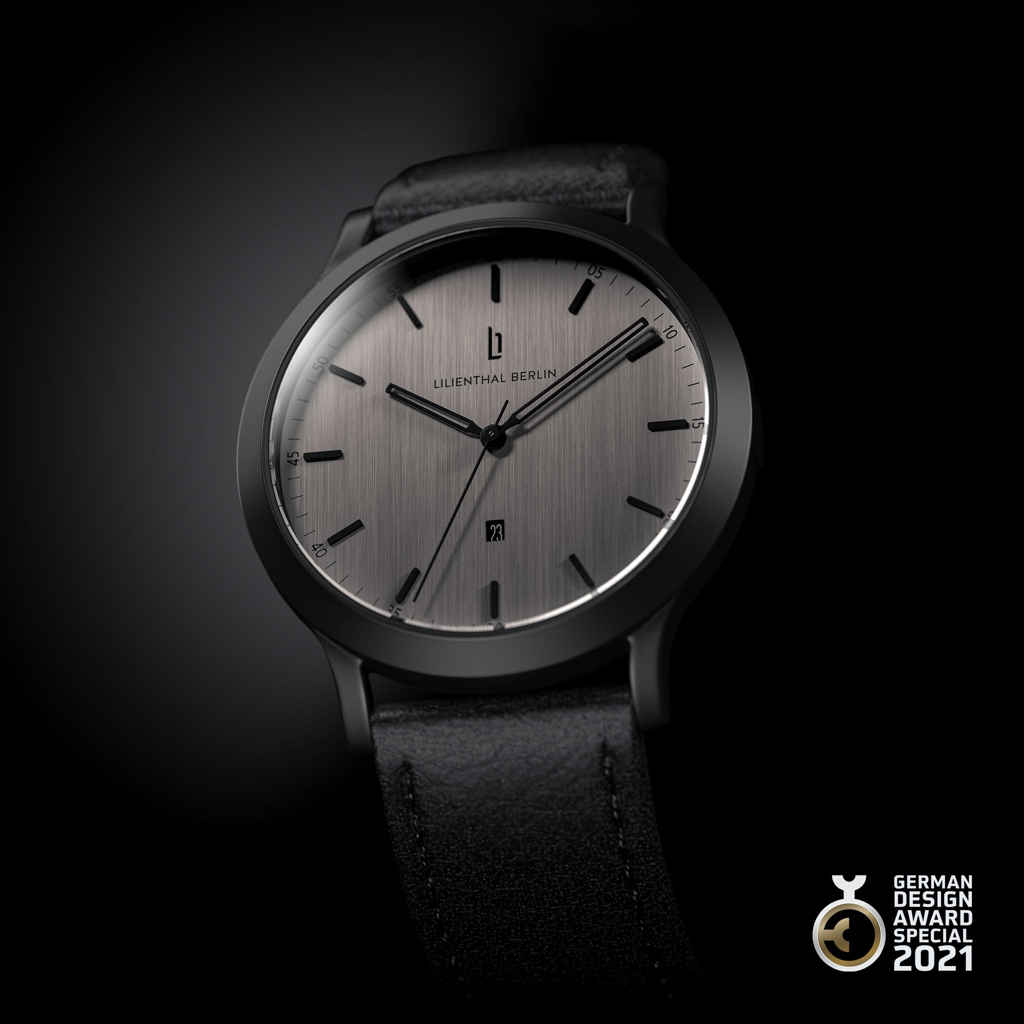 Minimalist silver analog watch with black leather strap, date display, and award badge