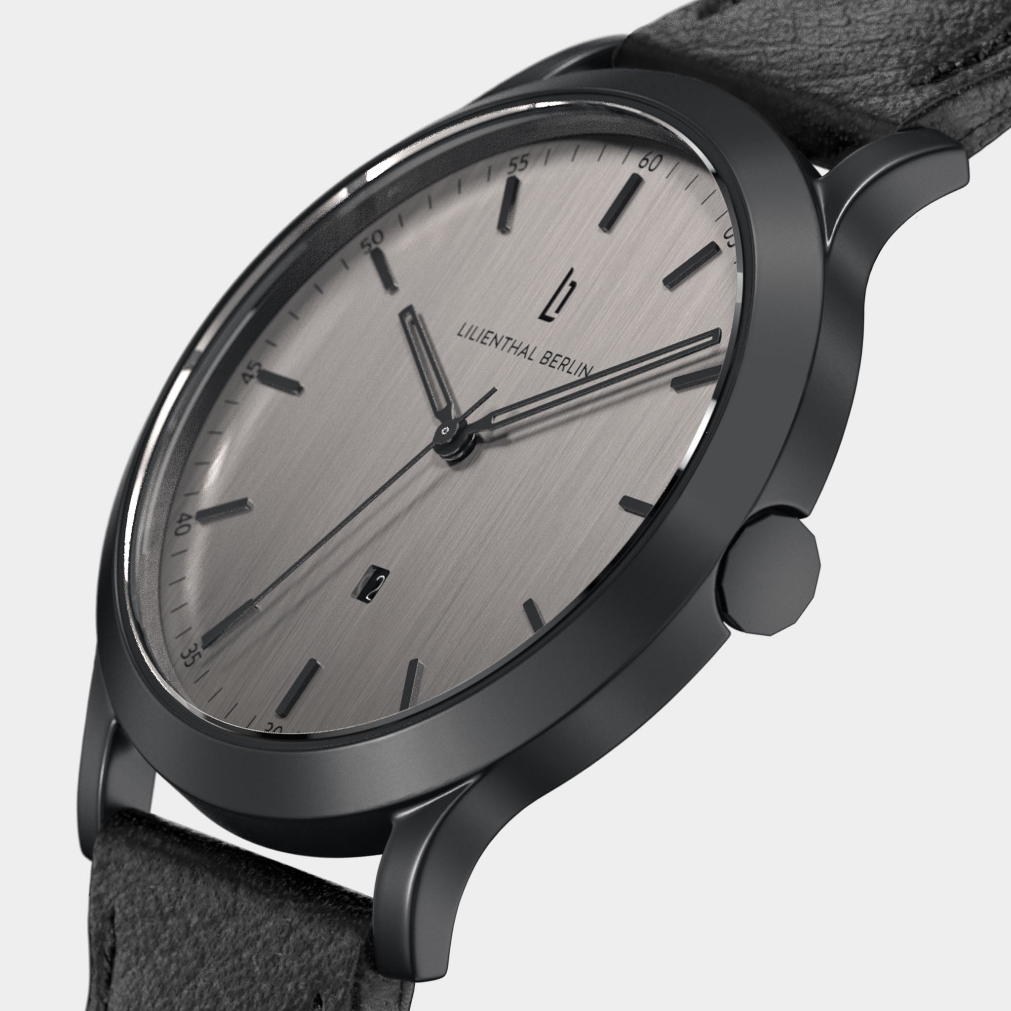 Minimalist silver watch with black leather strap and brushed metal dial