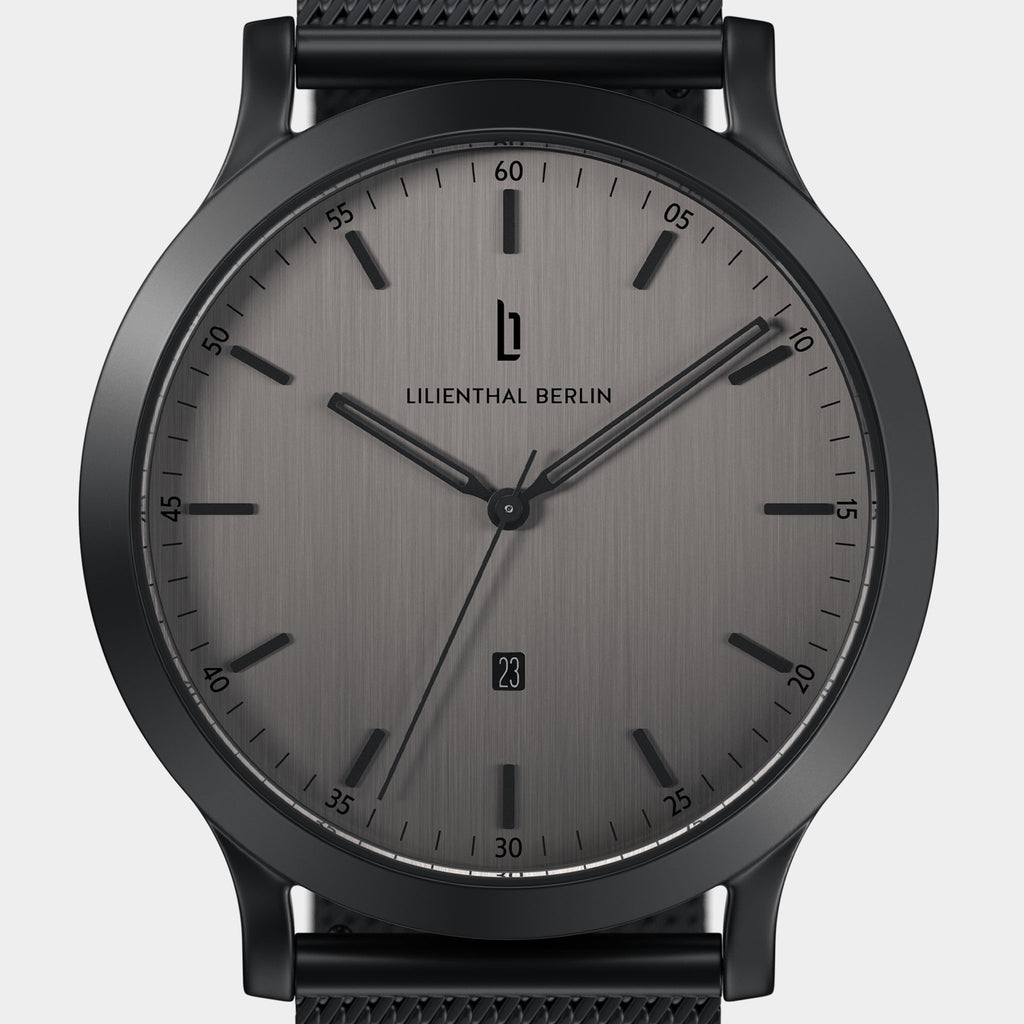 Minimalist black stainless steel wristwatch with grey brushed dial and date display