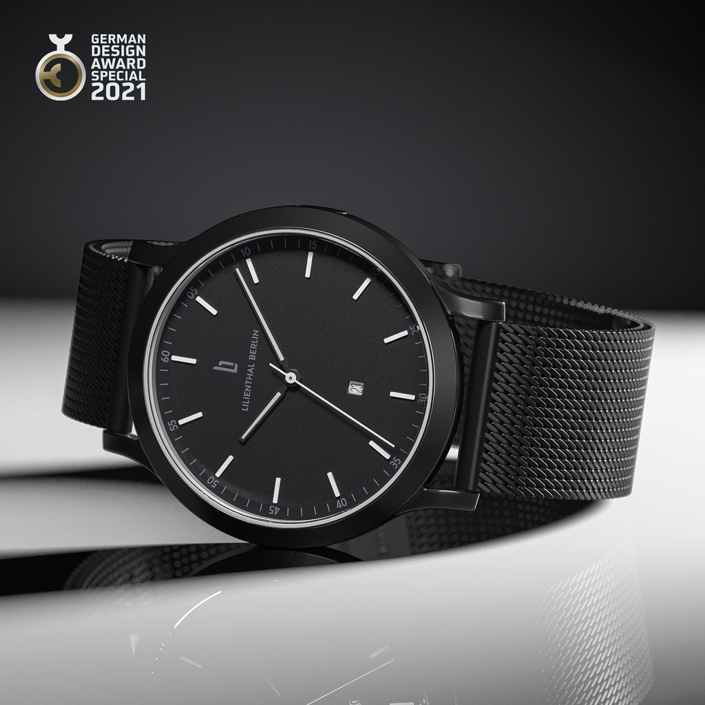 Minimalist black designer watch with mesh strap and date display, German Design Award 2021 winner
