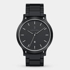Sleek black analog wristwatch with metal band, minimalist dial, date display at 6 o'clock.