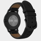 Back view of a black stainless steel watch with Huxley engraving and black leather strap