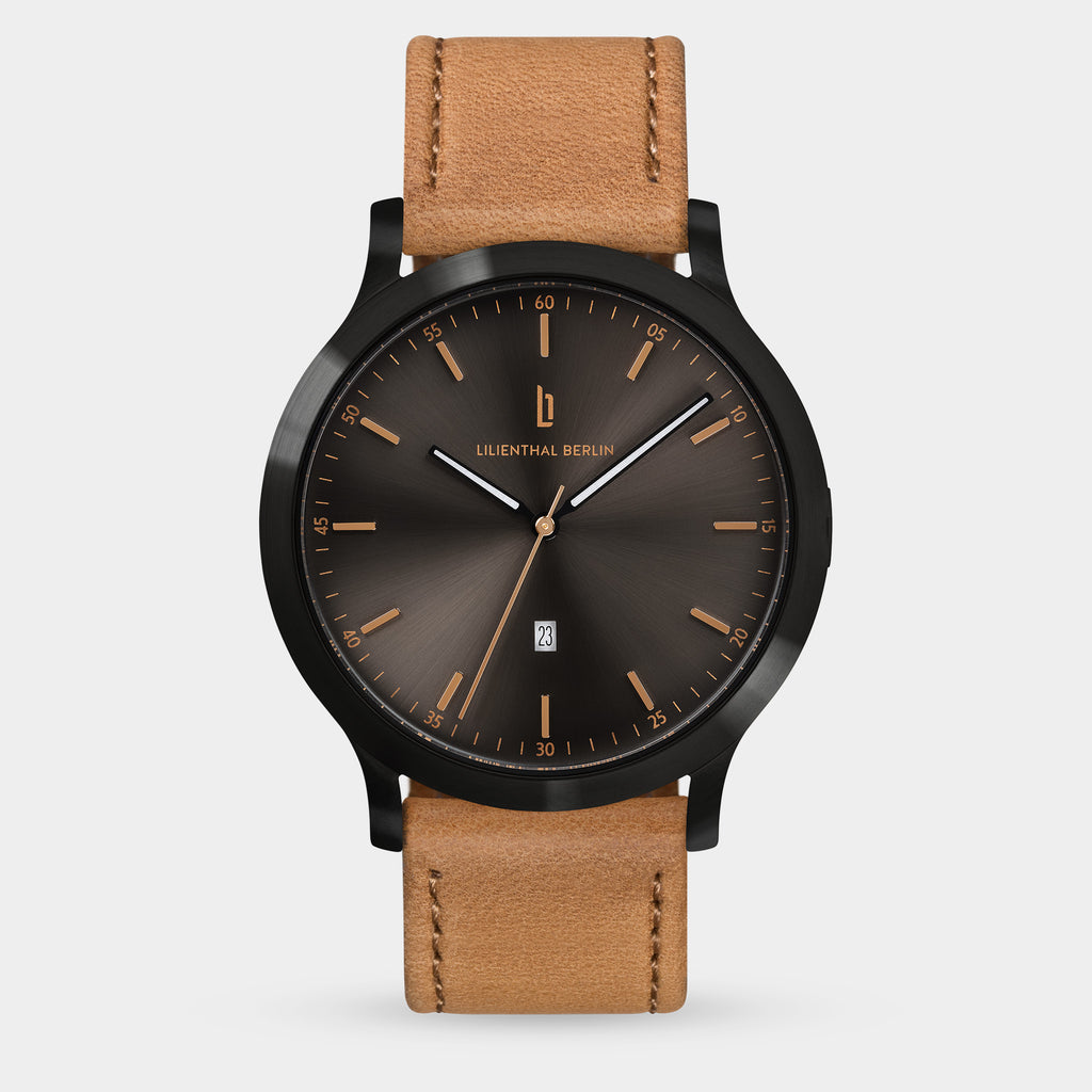 Men's analog wristwatch with black sunburst dial, gold markers, date display, and brown leather strap