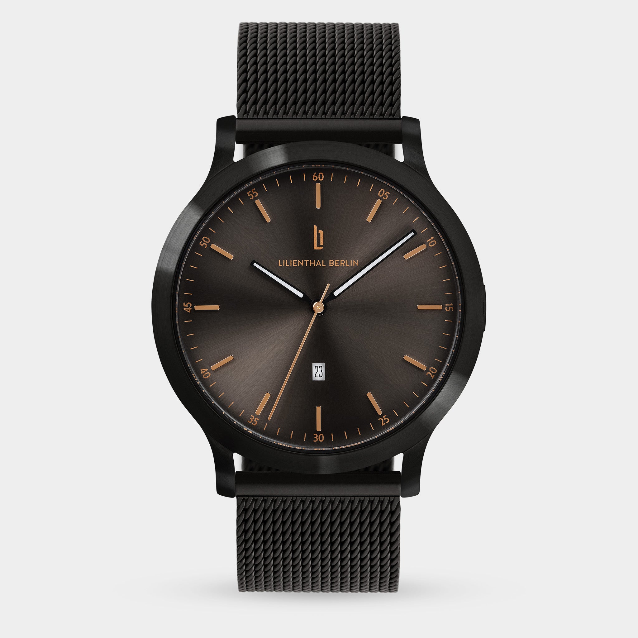 Minimalist black mesh strap watch with a dark sunburst dial and gold hour markers