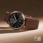 Men’s bronze wristwatch with black dial, brown leather strap, date window, German Design Award 2021