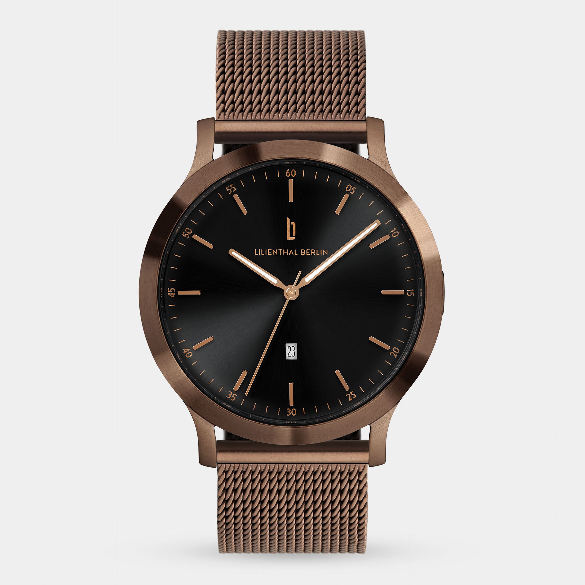 Minimalist bronze mesh strap watch with black dial and gold markers on white background