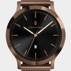 Rose gold stainless steel wristwatch with black dial, minimalist design, and date display.