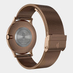 Rose gold stainless steel mesh watch band and caseback with engraved details, modern design.