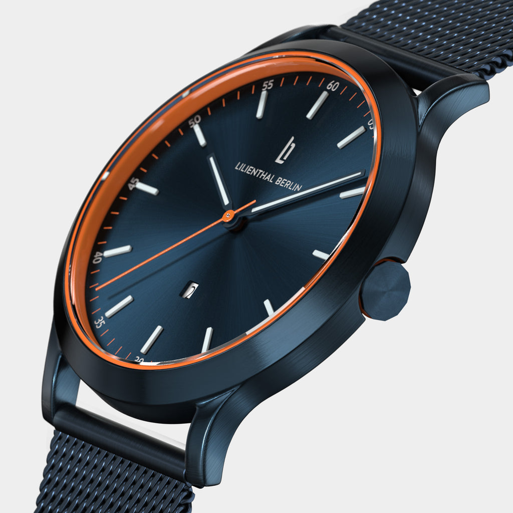 Sleek blue dial wristwatch with orange accents and mesh strap, modern minimalist design