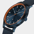 Sleek blue dial wristwatch with orange accents and mesh strap, modern minimalist design