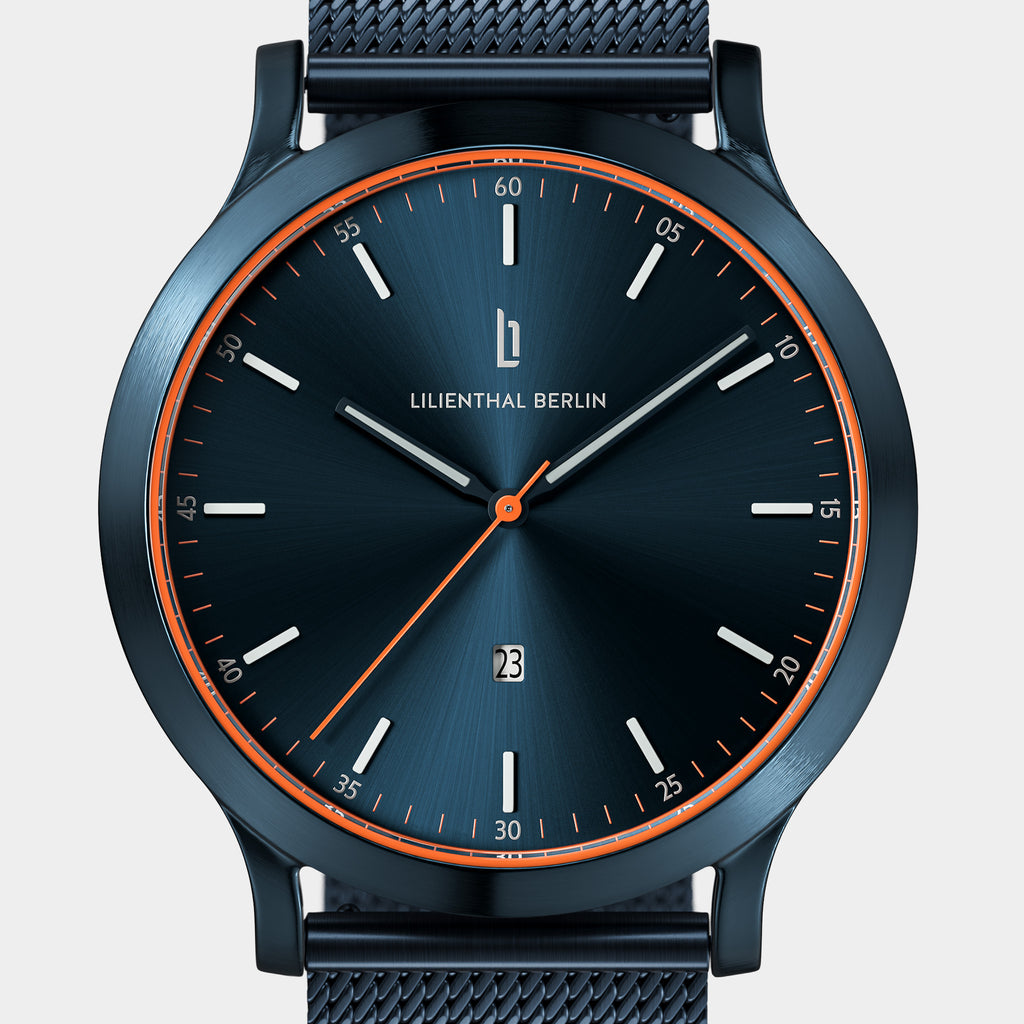 Blue stainless steel minimalist wristwatch with orange accents and date display on mesh strap
