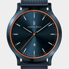 Blue stainless steel minimalist wristwatch with orange accents and date display on mesh strap