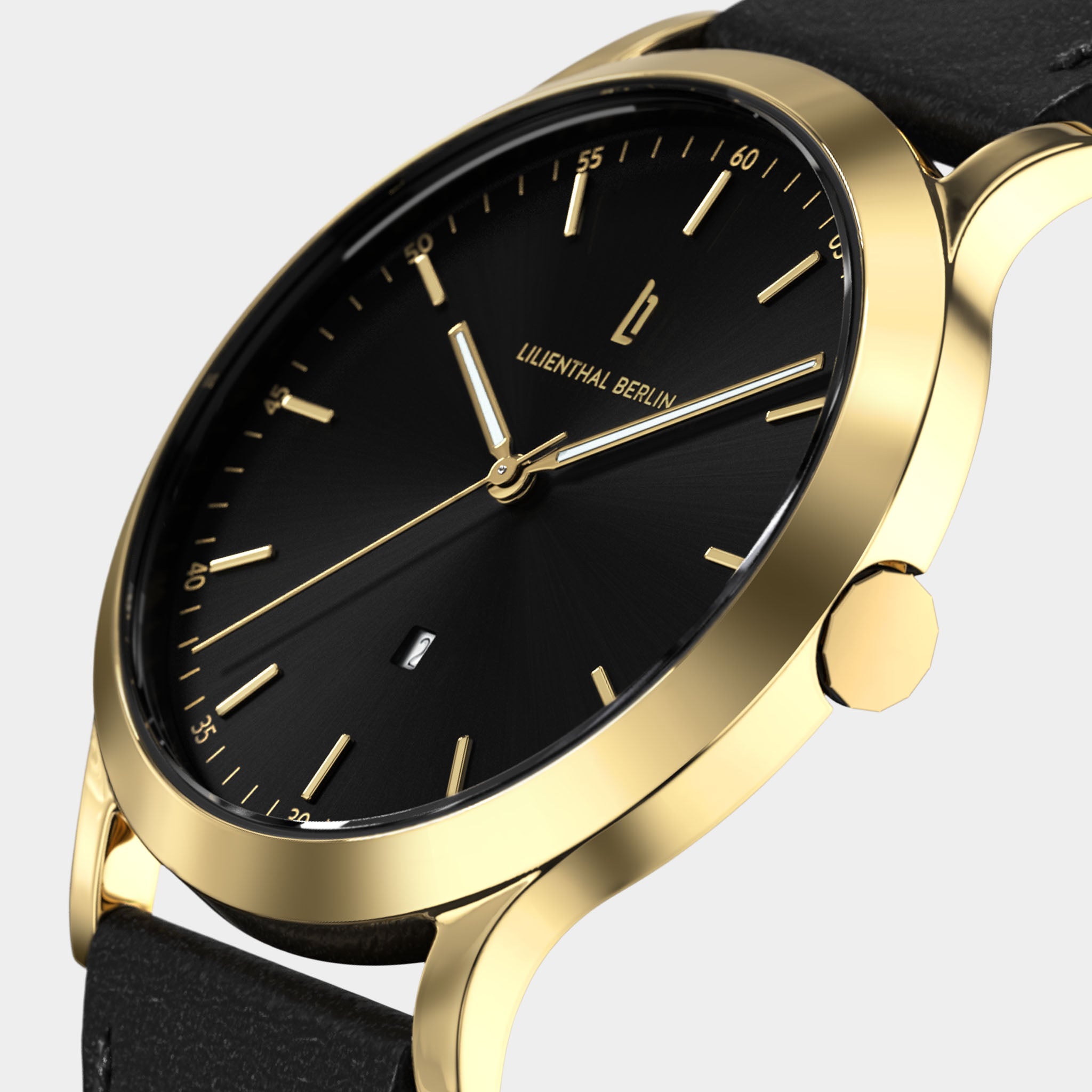 Gold case minimalist watch with black dial, date window, and black leather strap
