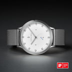 Minimalist silver mesh watch with white dial and iF Design Award 2017 badge on dark background.