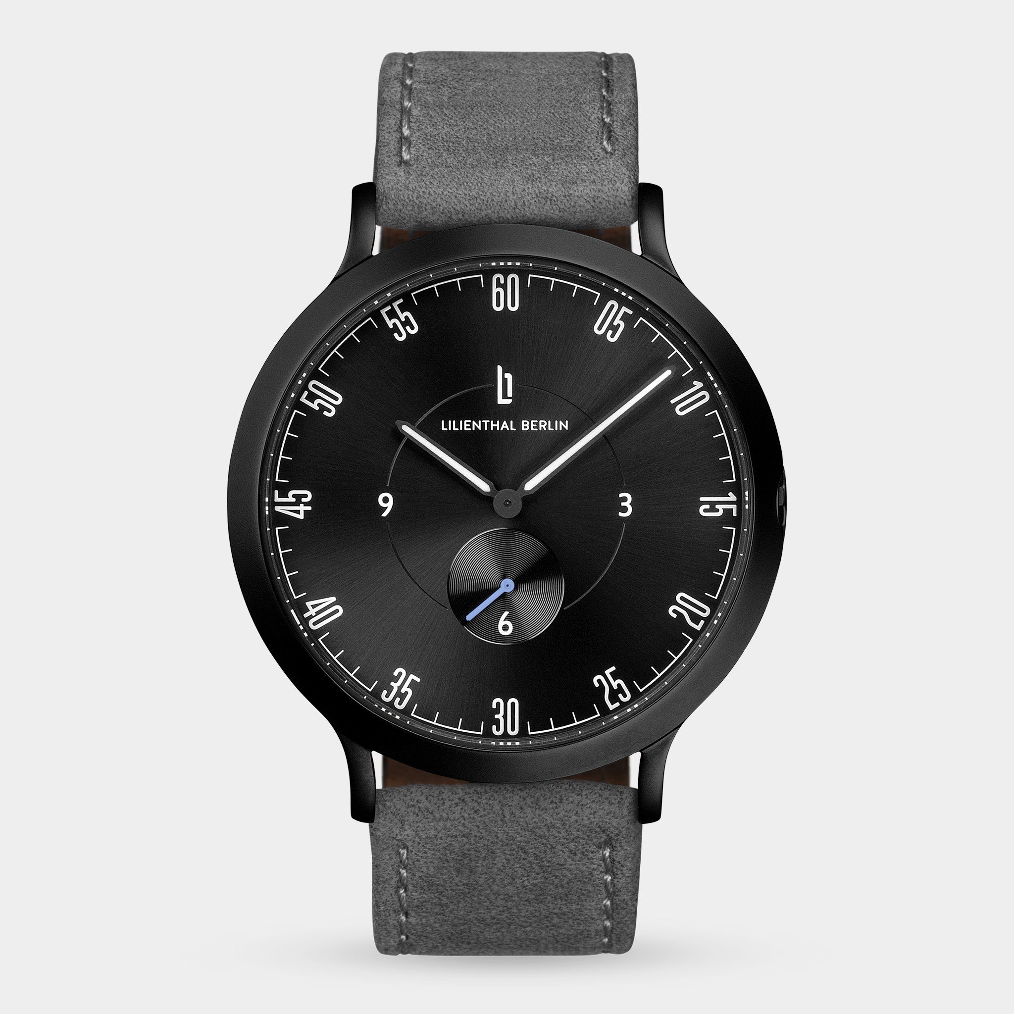 Minimalist black watch with grey leather strap, black dial, and white markers