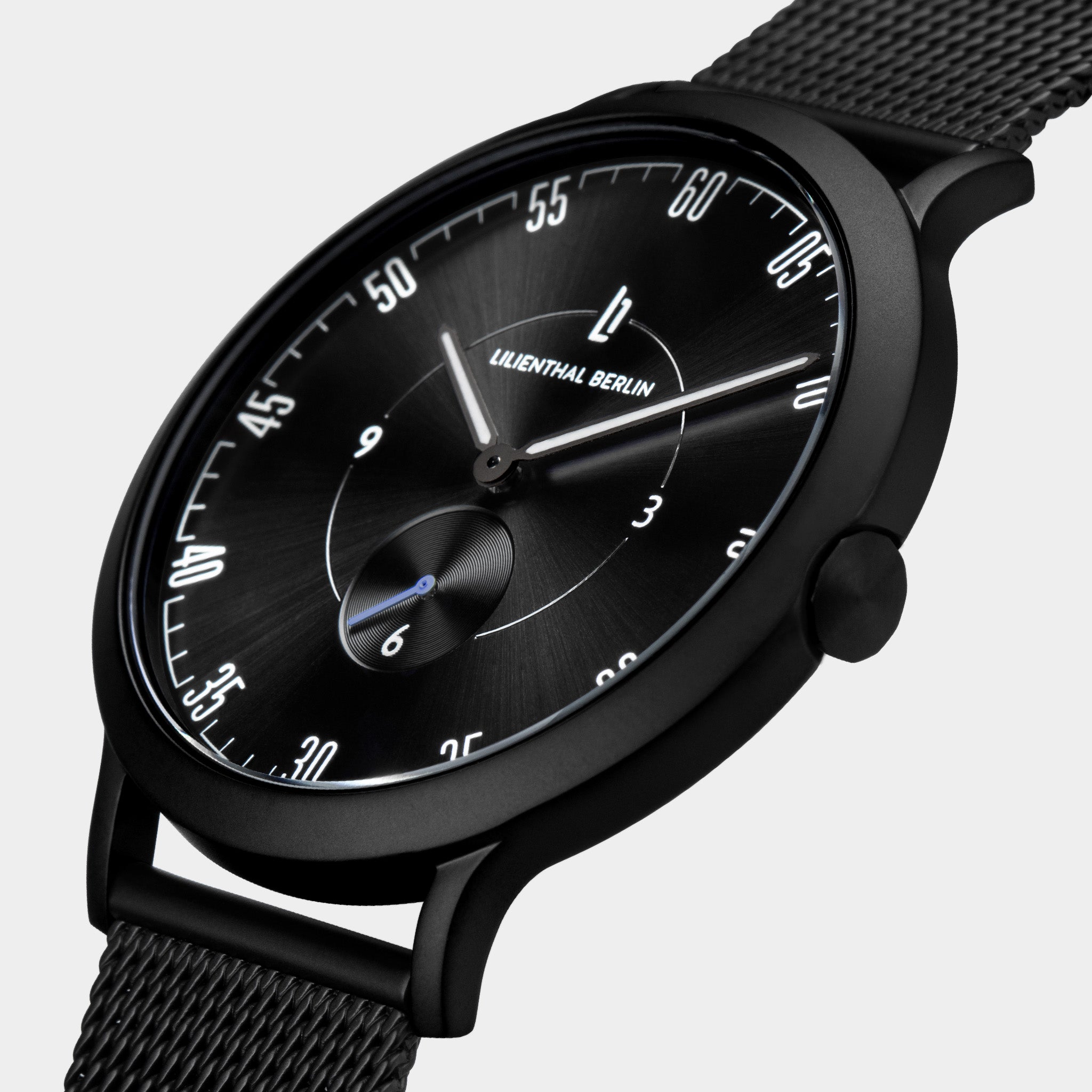 Sleek black wristwatch with mesh strap, minimalist dial and white numerals on display