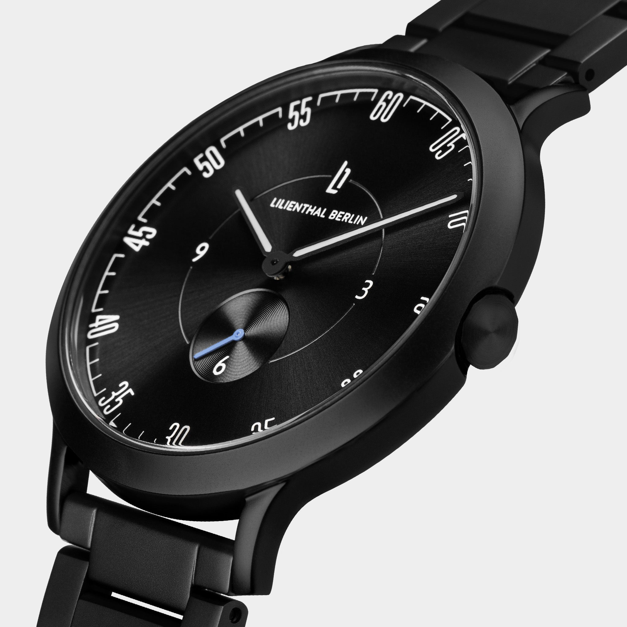 Black minimalist wristwatch with bold numerals, subdial, and metal bracelet on white background