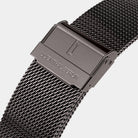 Close-up of a stainless steel mesh watch strap with engraved clasp on white background